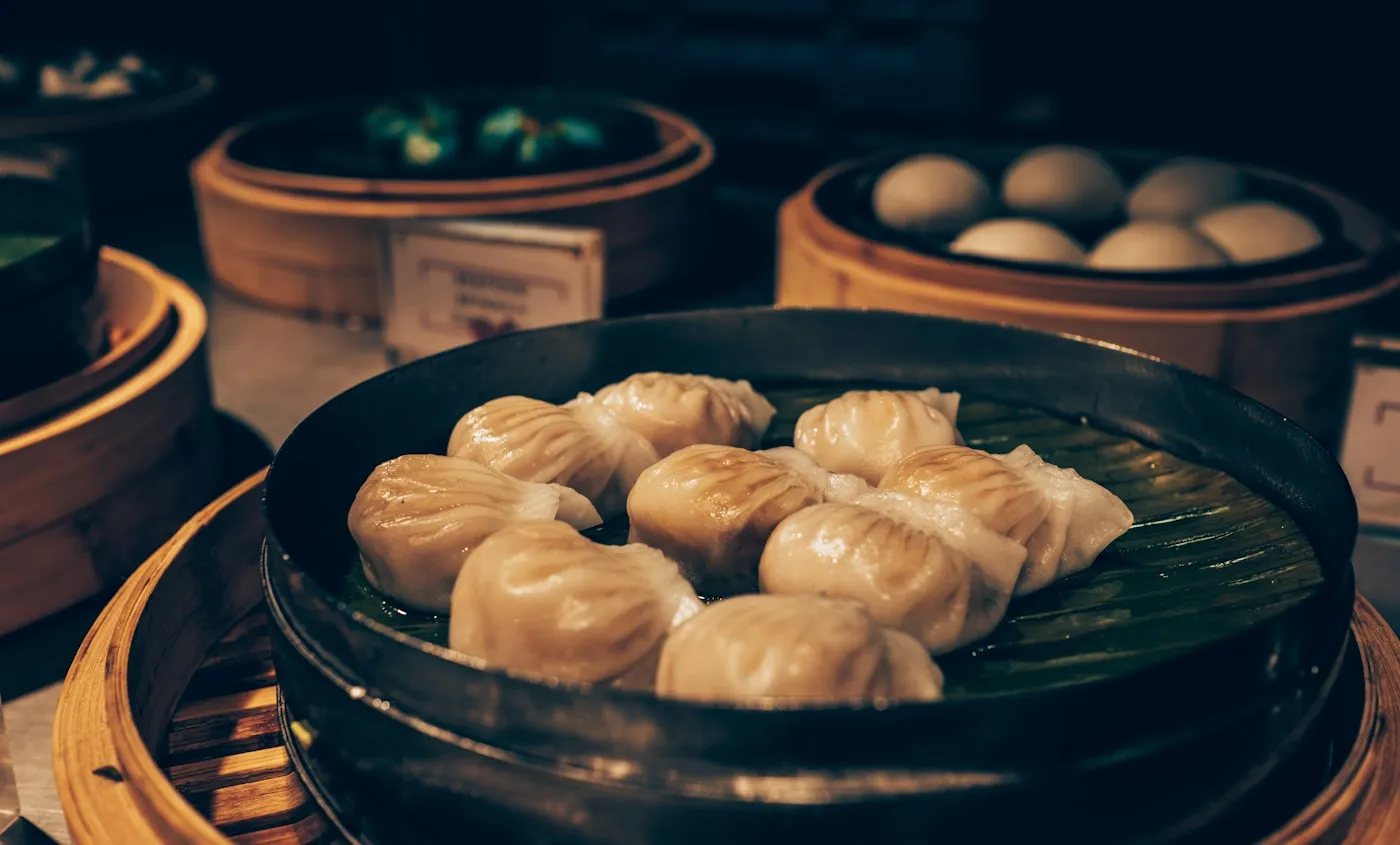 Freshly steamed dumplings in a bamboo basket
